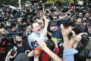 Zurab Japaridze surrounded by photographers